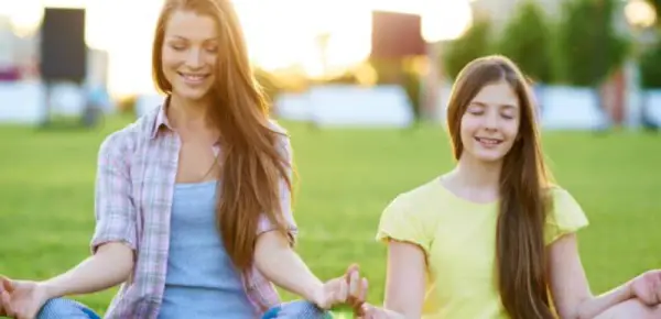 mom and kid meditating - Teaching Mindfulness to Kids and Teenagers tips activities