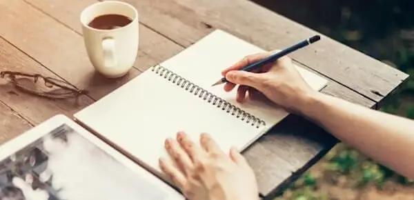 person writing a book - narrative therapy exercise