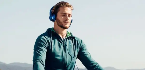 guy meditating with headphones on - Mindfulness Aid Apps relax melodies 